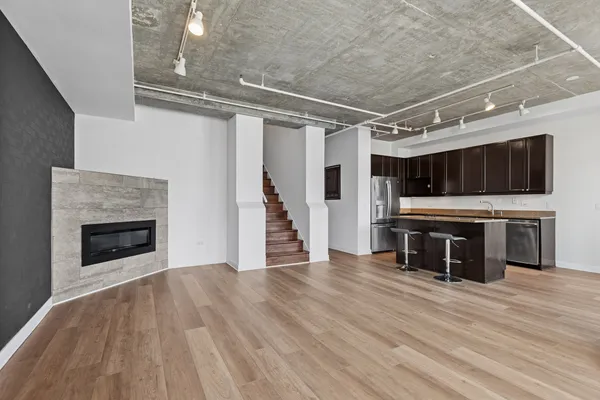 a view of a livingroom with an empty space and wooden floor