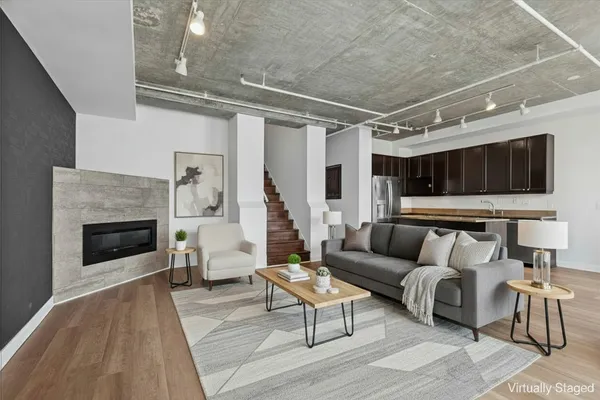 a living room with furniture and a fireplace