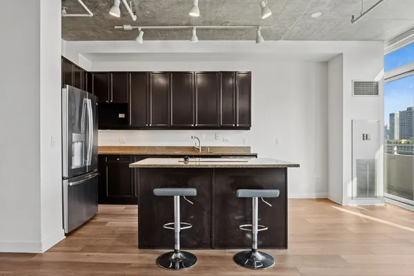 a kitchen with a sink appliances and cabinets