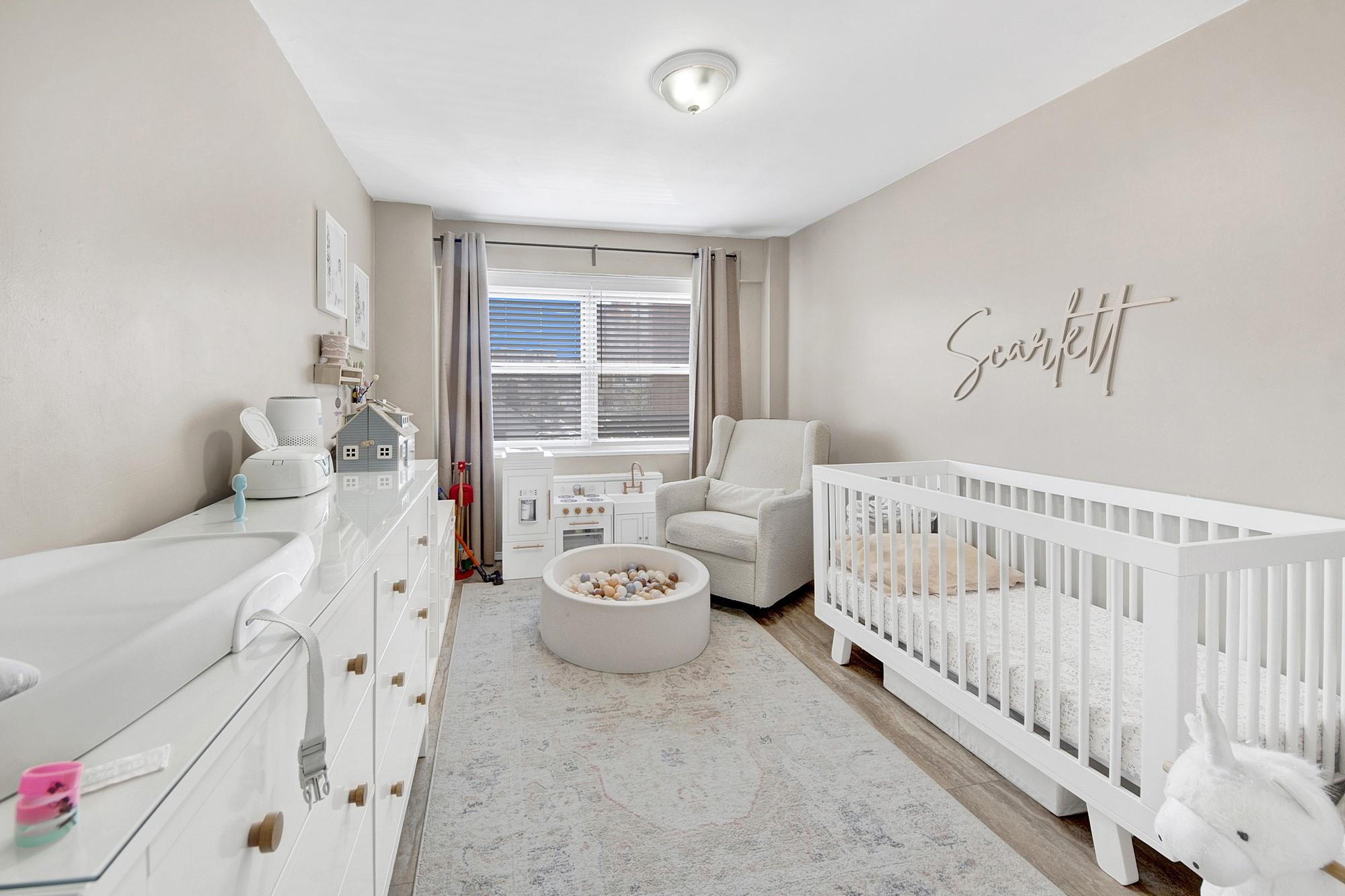 3130 Irwin Avenue, Unit 2C Bronx, NY 10463 - Photo 18 of 30 Bedroom with wood finished LVP floors and a nursery area