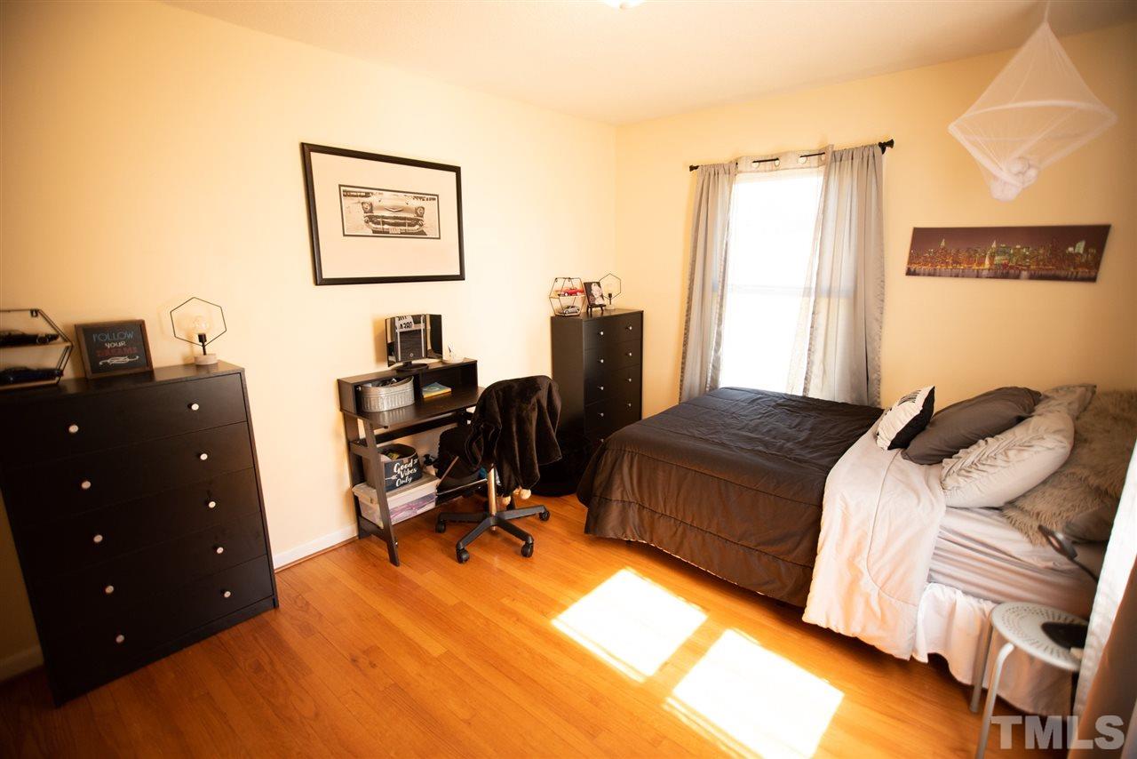 3029 Peebles Road Raleigh, NC 27616 - Photo 16 of 28 a bedroom with a bed and a desk