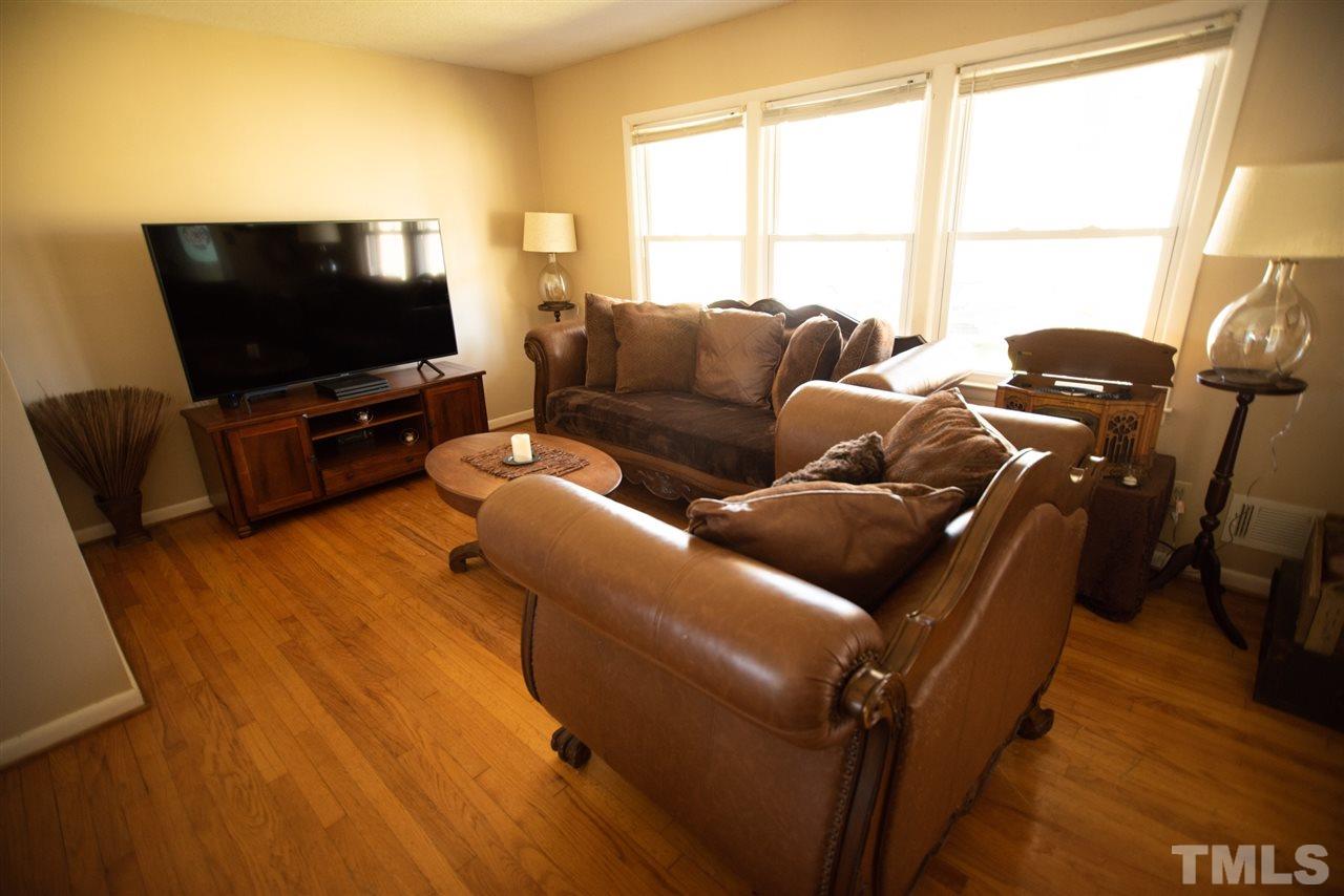 3029 Peebles Road Raleigh, NC 27616 - Photo 6 of 28 a living room with furniture and a flat screen tv