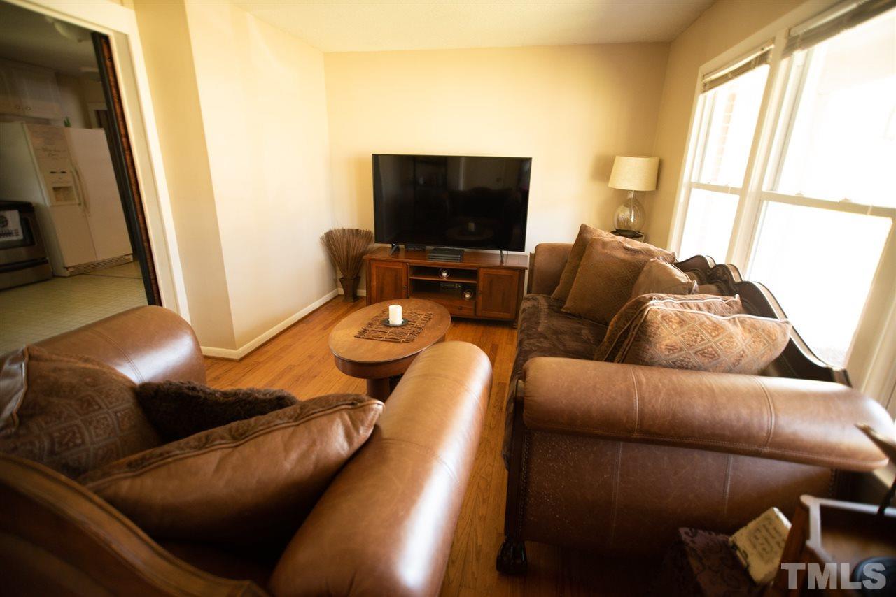 3029 Peebles Road Raleigh, NC 27616 - Photo 7 of 28 a living room with furniture and a flat screen tv