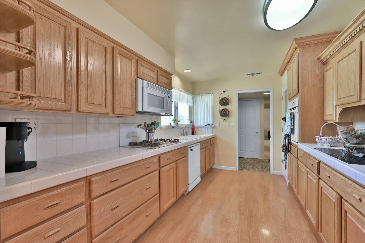 3840 Greenstone Road Placerville, CA 95667 - Photo 14 of 49 a kitchen with granite countertop a sink stove and cabinets