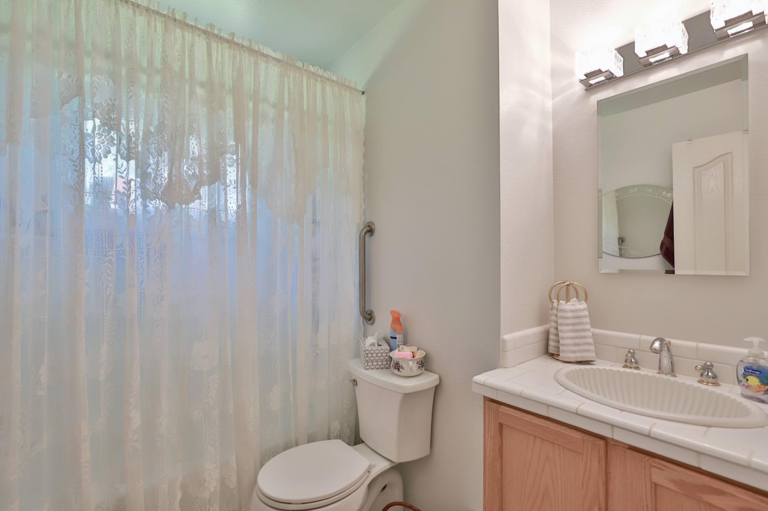 3840 Greenstone Road Placerville, CA 95667 - Photo 17 of 49 a bathroom with a granite countertop sink vanity mirror and toilet