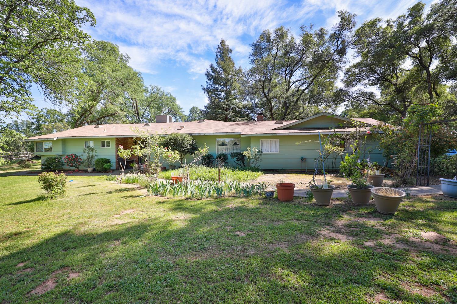 3840 Greenstone Road Placerville, CA 95667 - Photo 2 of 49 a view of a swimming pool with lawn chairs under an umbrella
