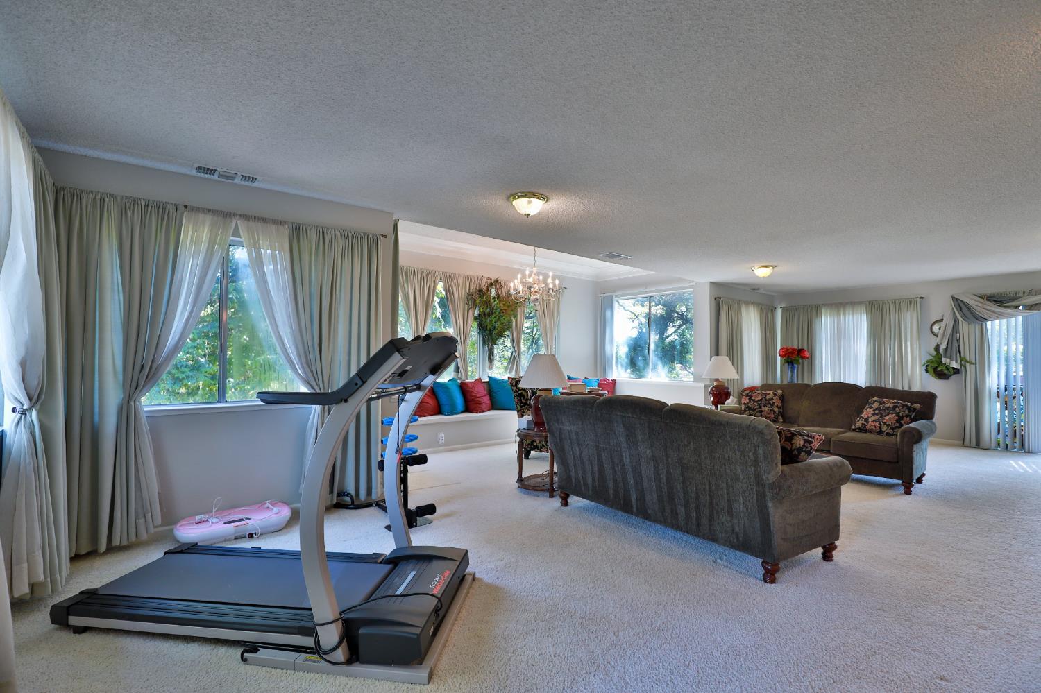 3840 Greenstone Road Placerville, CA 95667 - Photo 5 of 49 a living room with furniture gym equipment and a large window
