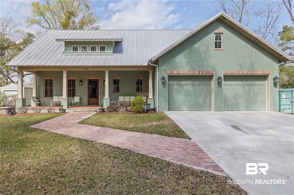 2730 Gator Road Mobile, AL 36605 - Photo 1 of 42 View of front of house with a porch, concrete driveway, a front lawn, and brick siding