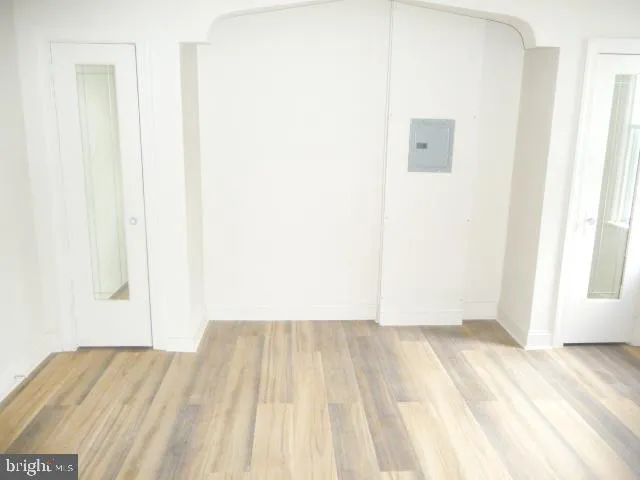 a view of a room with wooden floor and a window