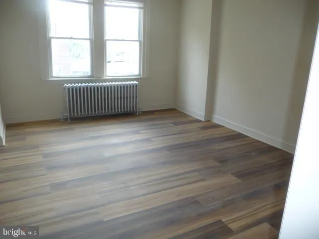 an empty room with wooden floor