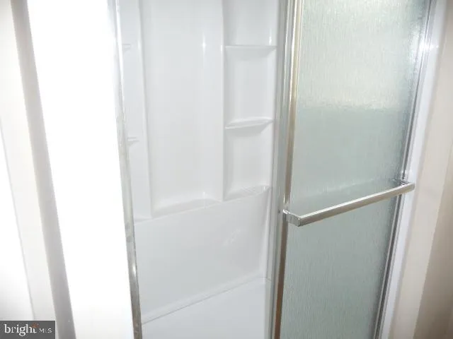 a bathroom with a glass shower door