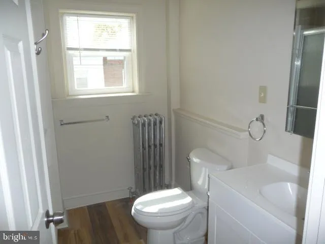 a white toilet sitting next to a bathroom sink