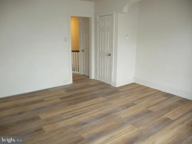 a view of a room with wooden floor and bathroom