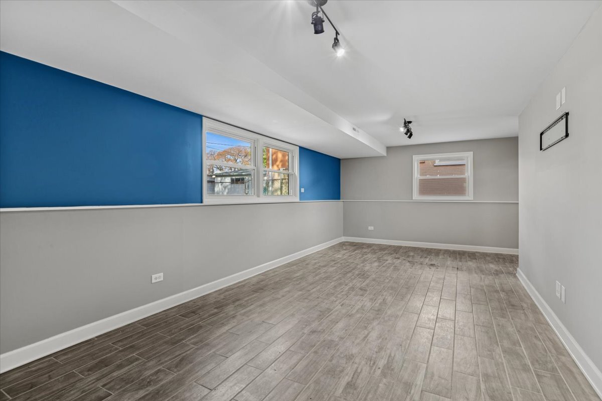 8846 North Ozanam Avenue Niles, IL 60714 - Photo 16 of 24 an empty room with wooden floor and windows
