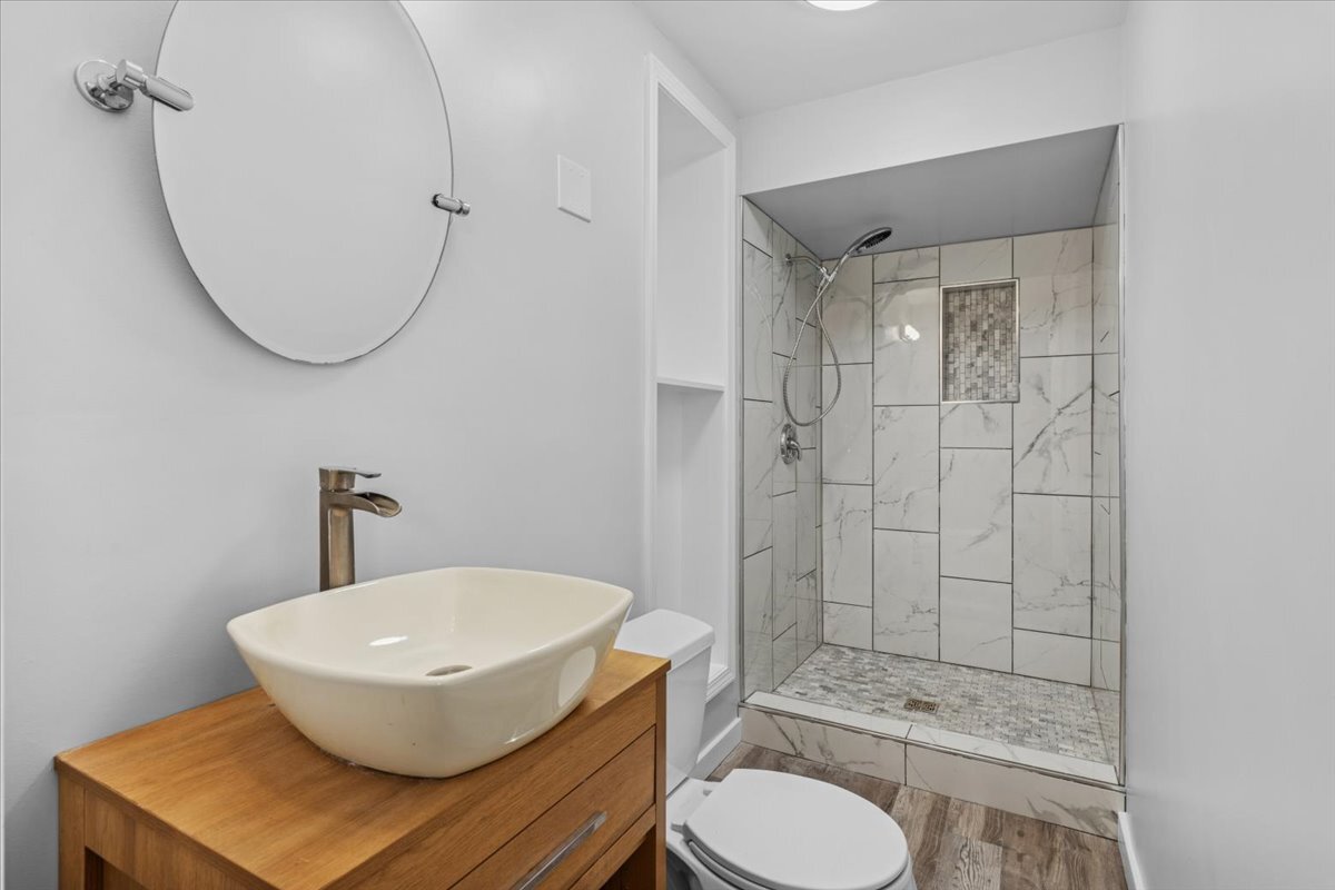 8846 North Ozanam Avenue Niles, IL 60714 - Photo 17 of 24 a bathroom with a sink toilet and shower