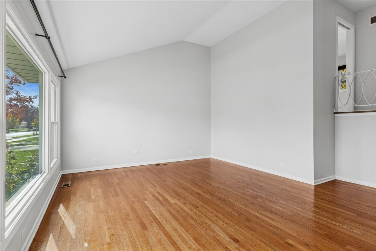 8846 North Ozanam Avenue Niles, IL 60714 - Photo 3 of 24 a view of empty room with wooden floor and fan