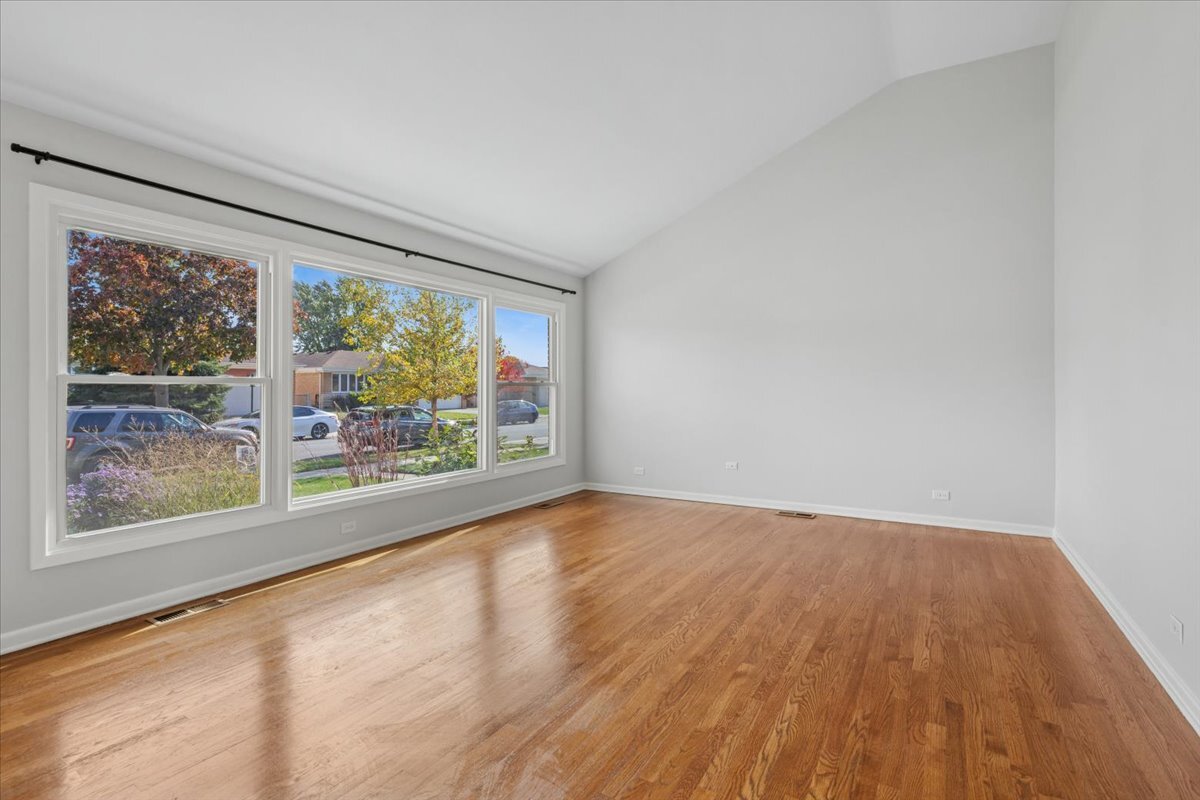 8846 North Ozanam Avenue Niles, IL 60714 - Photo 4 of 24 a view of room with window and wooden floor