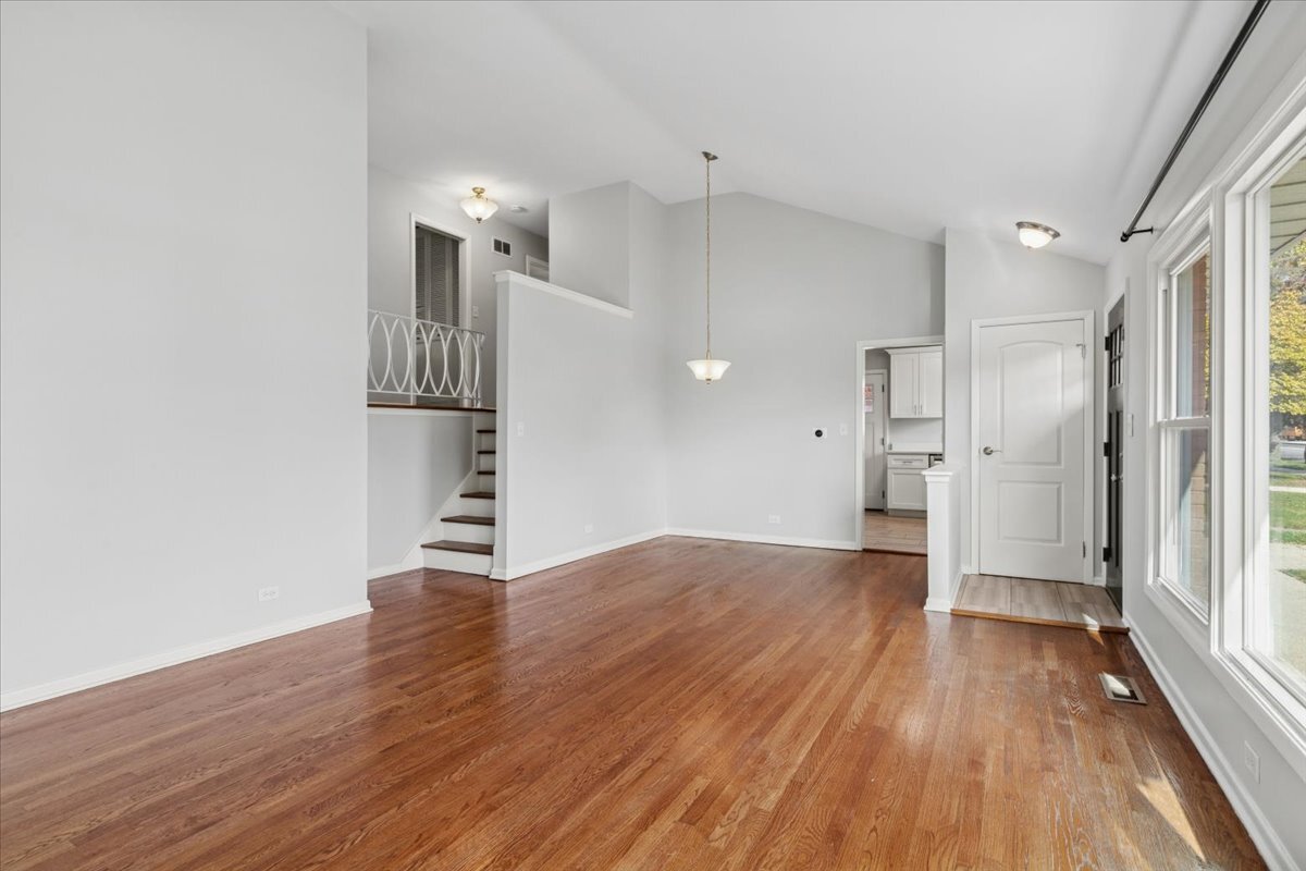 8846 North Ozanam Avenue Niles, IL 60714 - Photo 5 of 24 a view of empty room with wooden floor and window