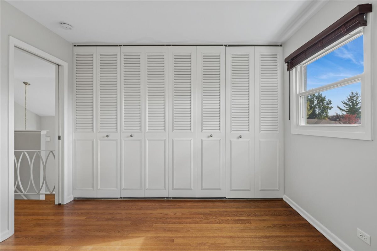 8846 North Ozanam Avenue Niles, IL 60714 - Photo 8 of 24 a view of empty room with wooden floor