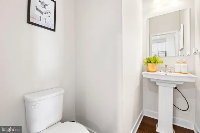 a bathroom with a sink a toilet and a window