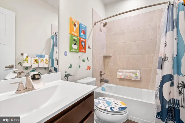 a bathroom with a sink mirror vanity and toilet