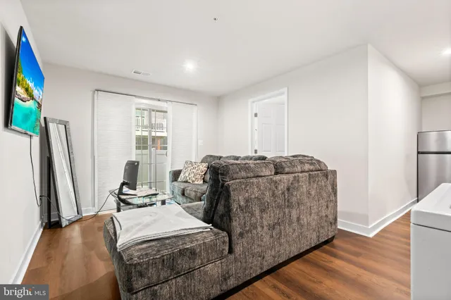 a living room with furniture window and a flat screen tv