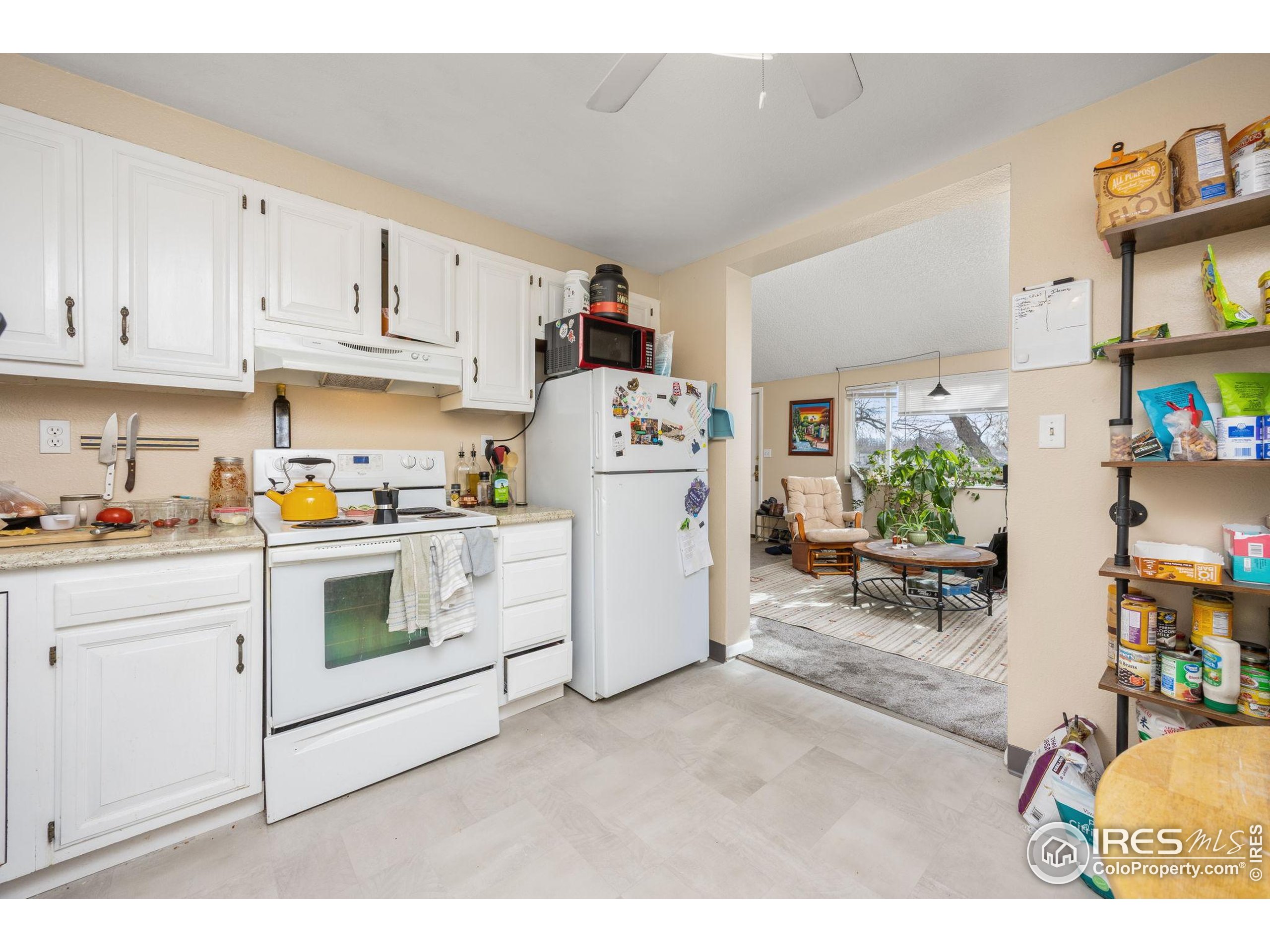 701 Aztec Drive Fort Collins, CO 80521 - Photo 19 of 43 a kitchen with cabinets and white appliances
