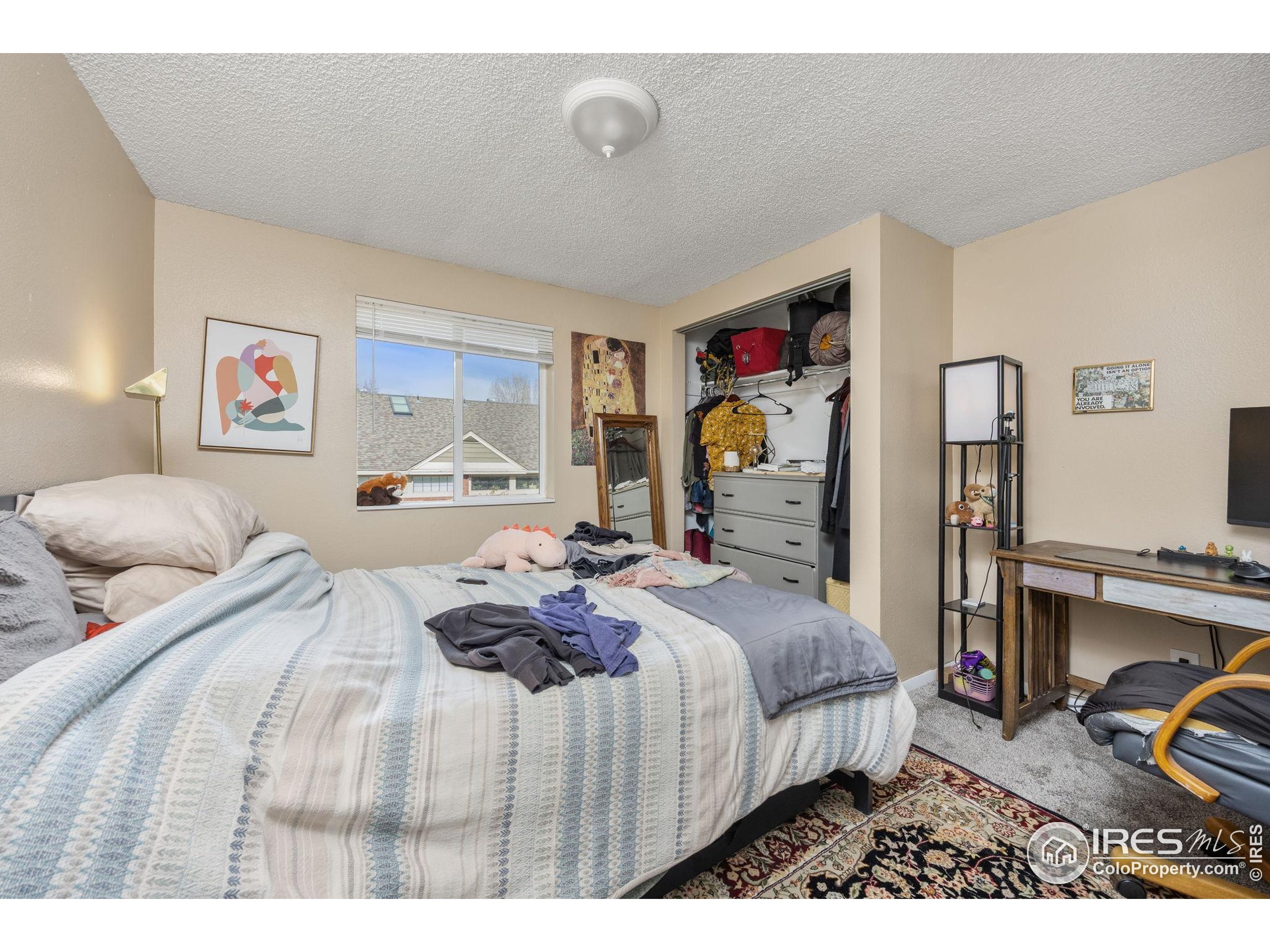 701 Aztec Drive Fort Collins, CO 80521 - Photo 20 of 43 a bedroom with a bed and a view of kitchen