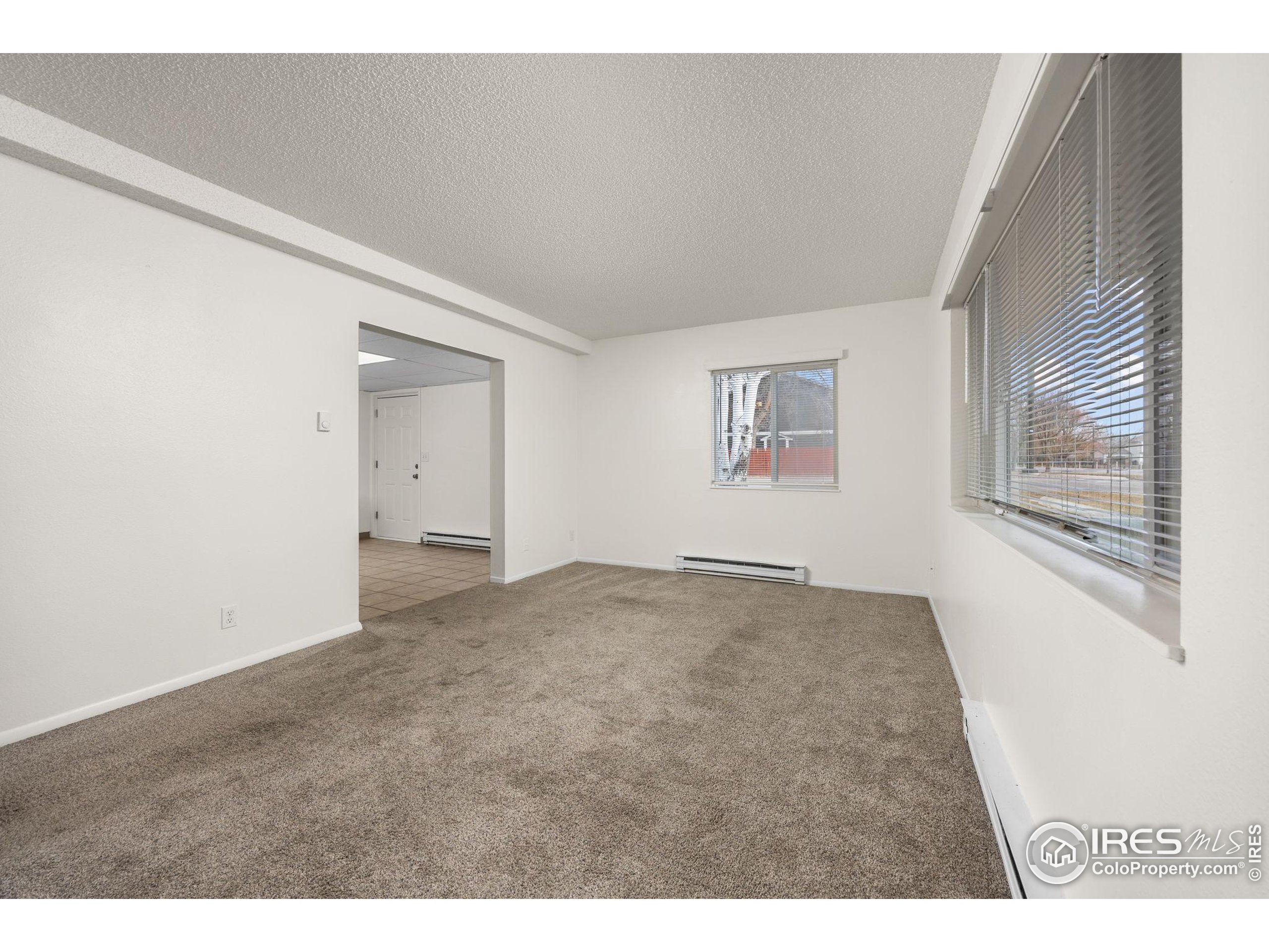 701 Aztec Drive Fort Collins, CO 80521 - Photo 24 of 43 a view of empty room with windows