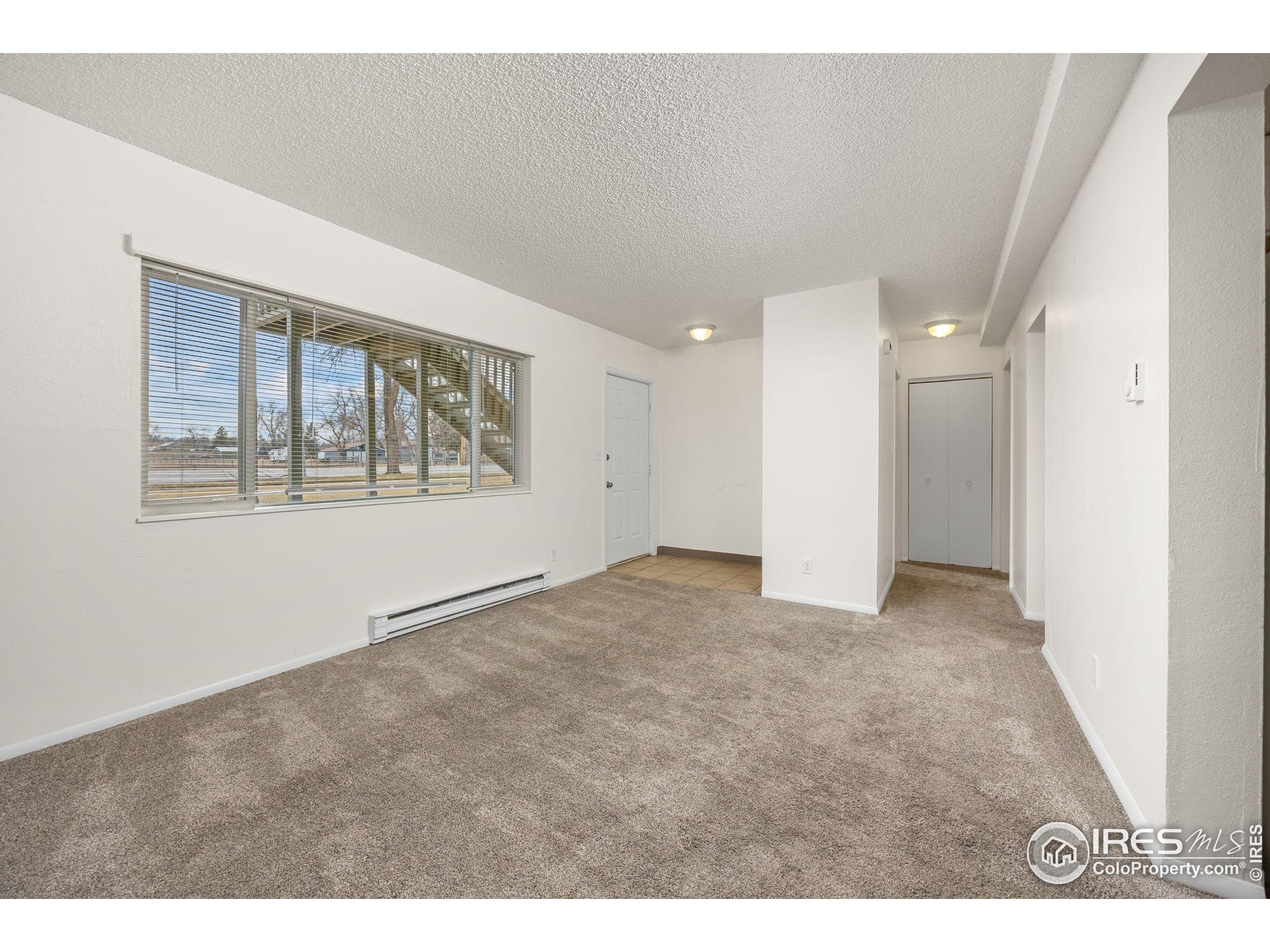 701 Aztec Drive Fort Collins, CO 80521 - Photo 25 of 43 a view of an empty room with a window