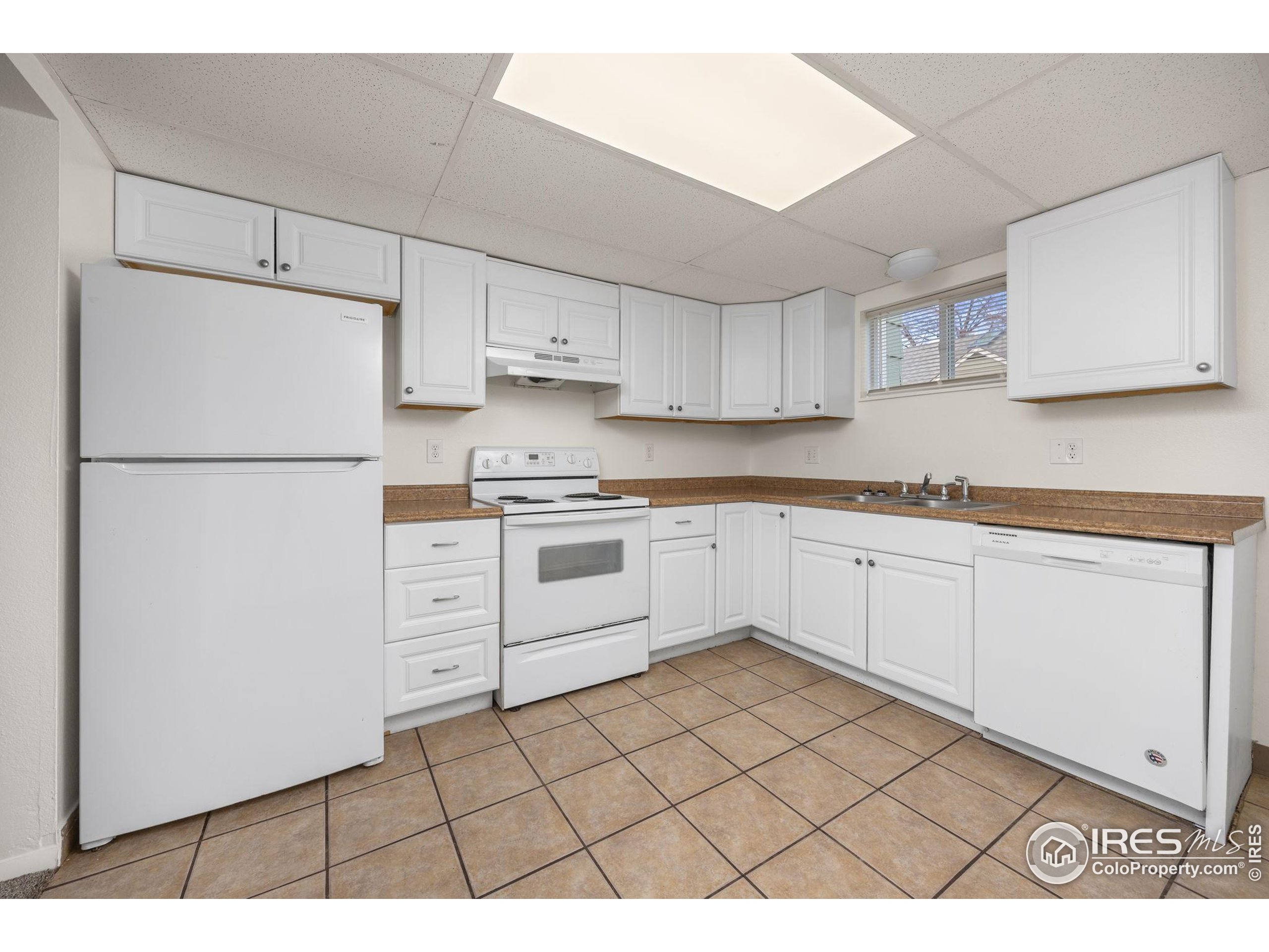 701 Aztec Drive Fort Collins, CO 80521 - Photo 26 of 43 a kitchen with white cabinets and white appliances