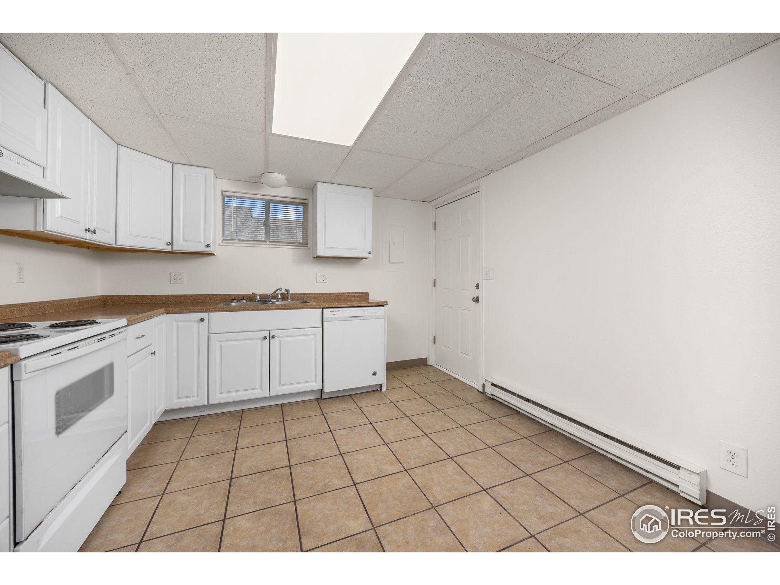 701 Aztec Drive Fort Collins, CO 80521 - Photo 27 of 43 a kitchen with a stove a sink and a microwave