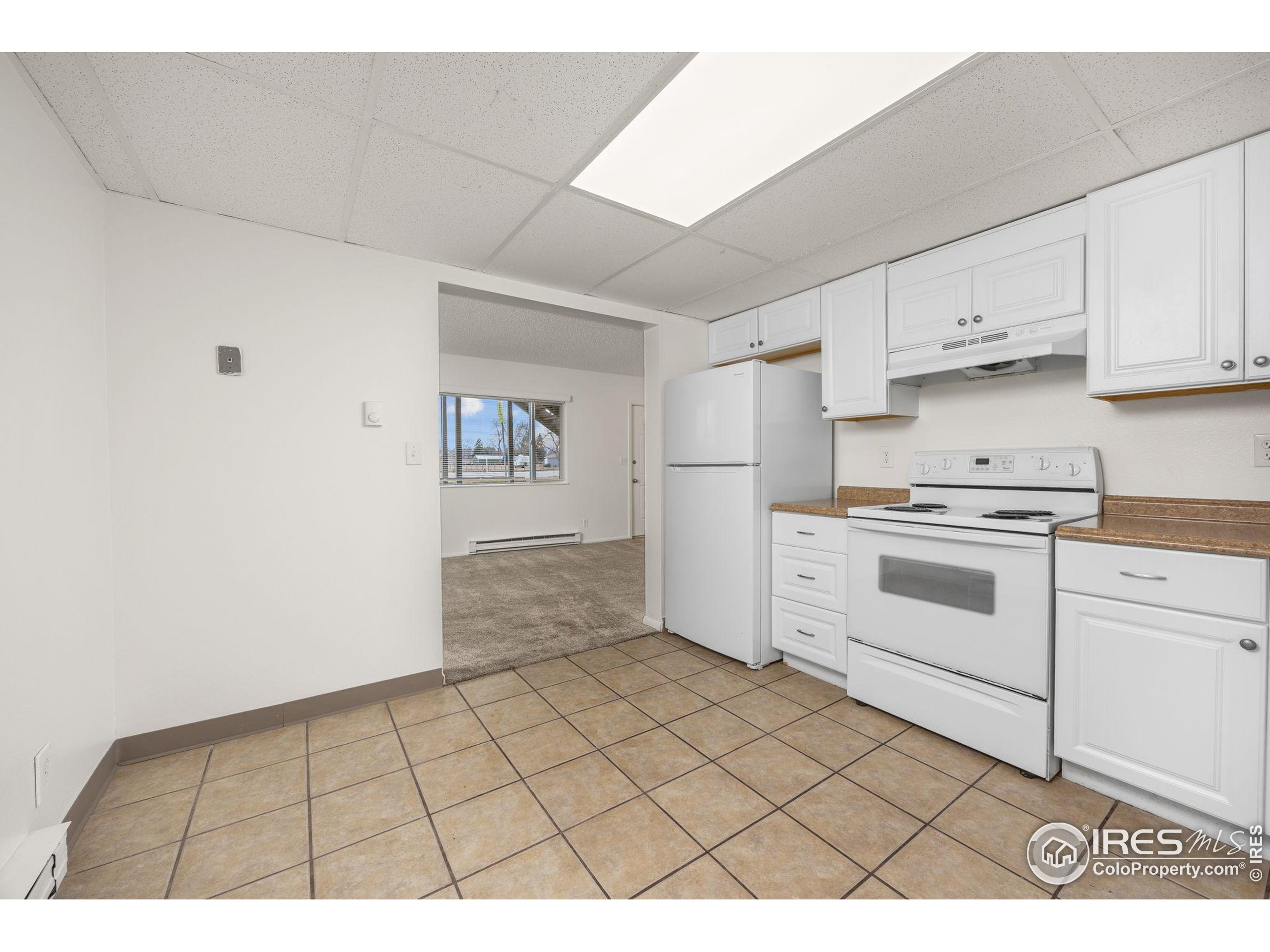 701 Aztec Drive Fort Collins, CO 80521 - Photo 28 of 43 a kitchen with white cabinets a sink and white appliances