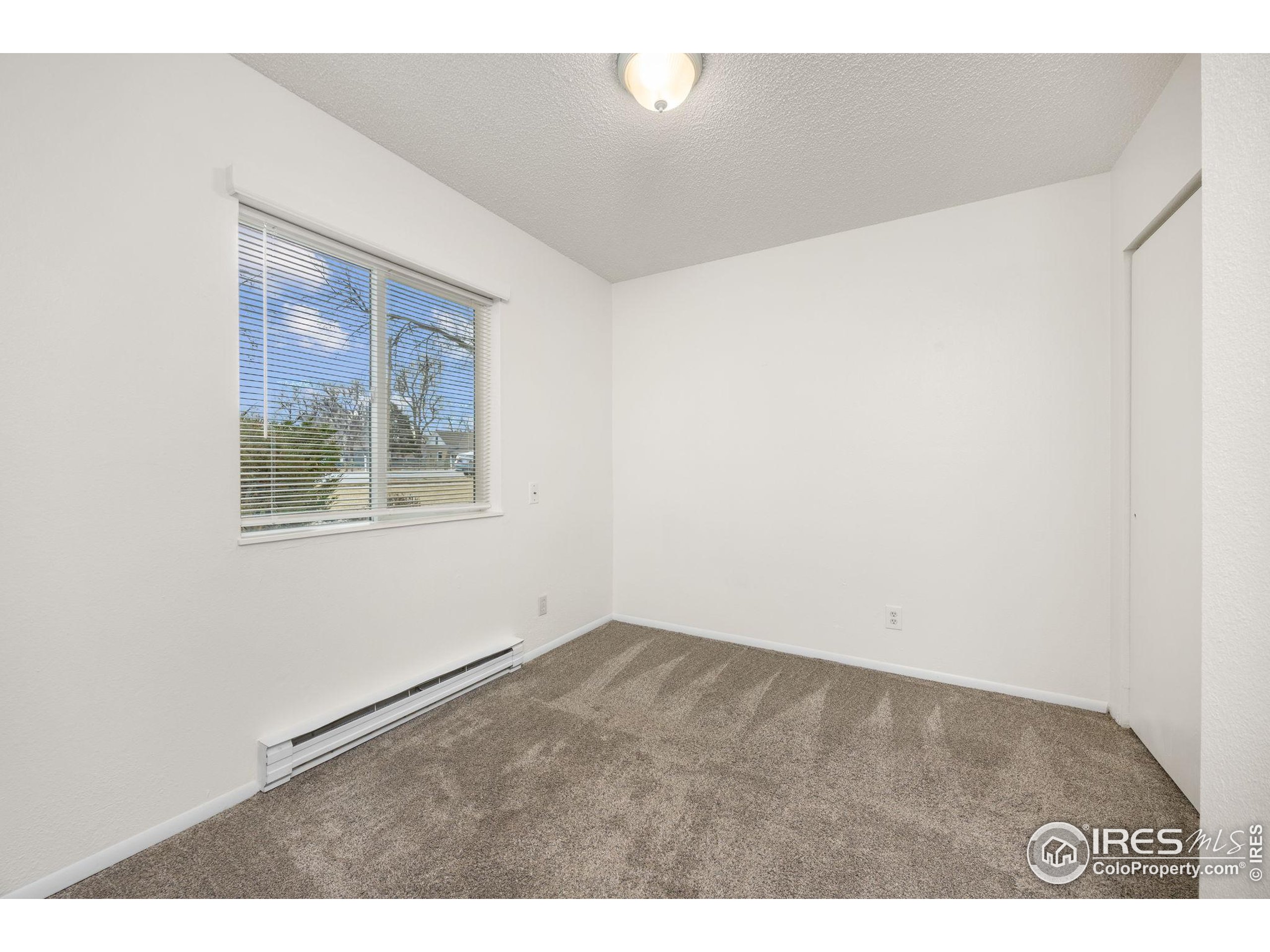 701 Aztec Drive Fort Collins, CO 80521 - Photo 30 of 43 an empty room with windows