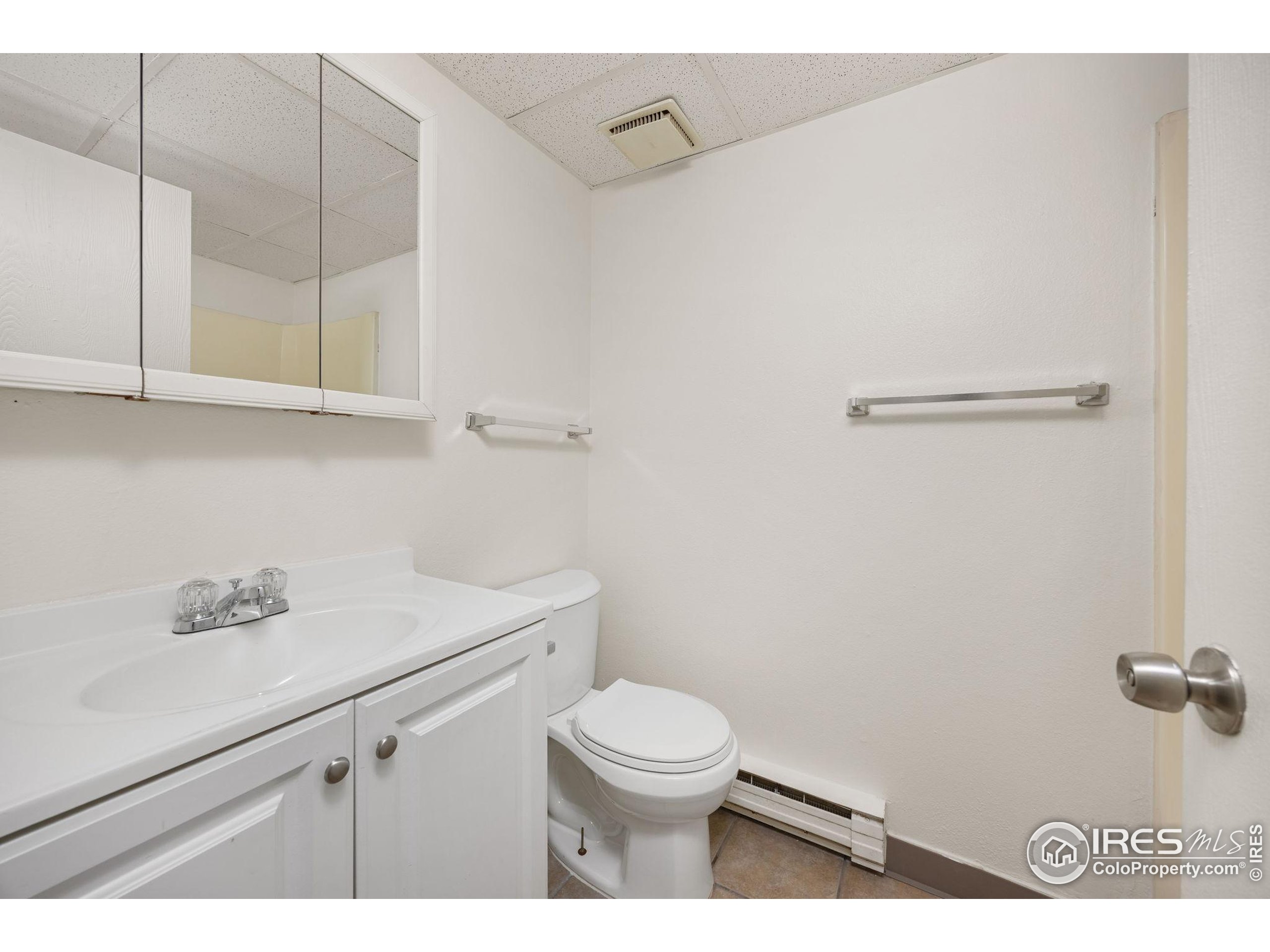 701 Aztec Drive Fort Collins, CO 80521 - Photo 31 of 43 a bathroom with a toilet a sink and mirror