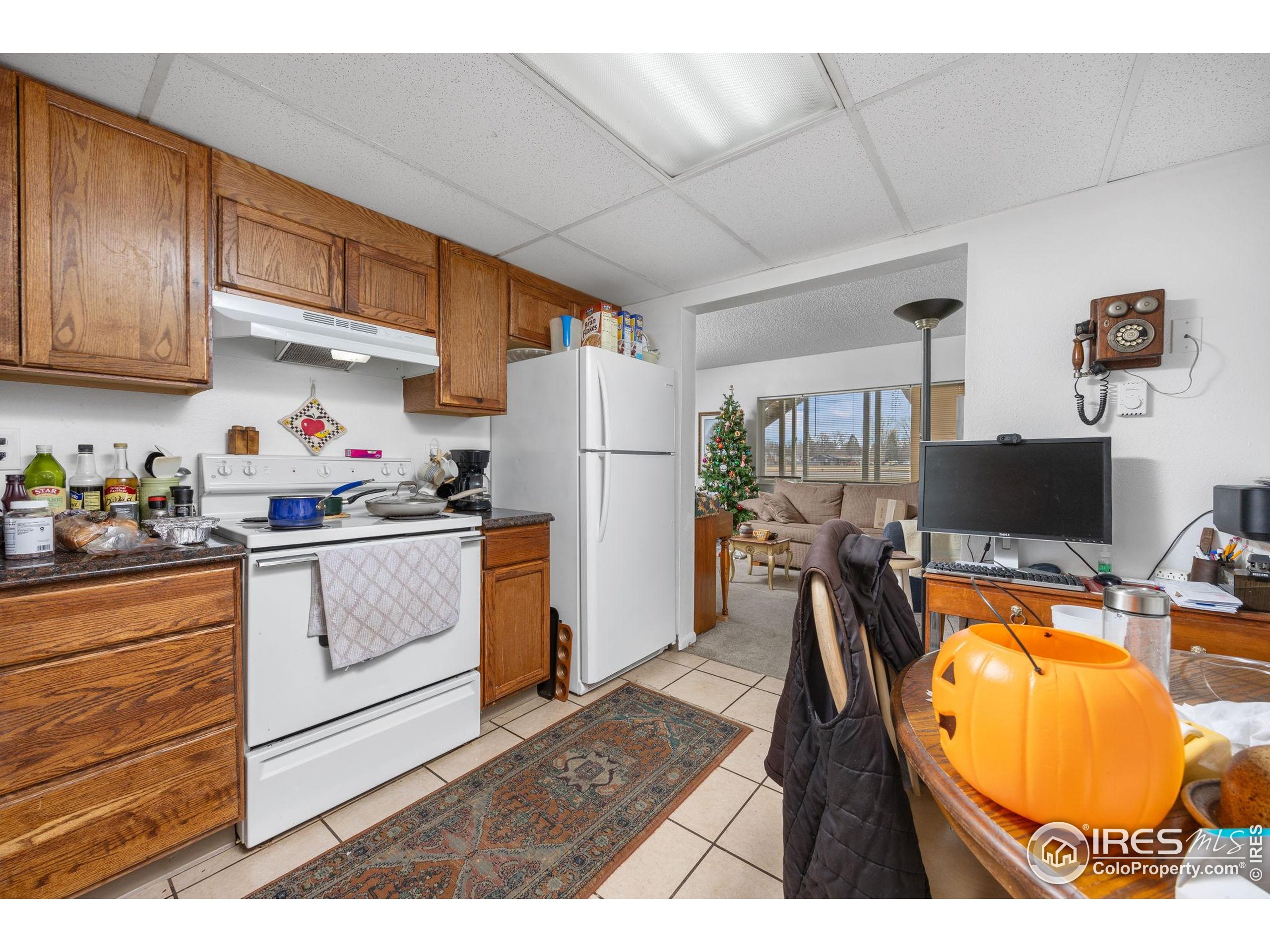 701 Aztec Drive Fort Collins, CO 80521 - Photo 36 of 43 a kitchen with a wooden floor and white appliances