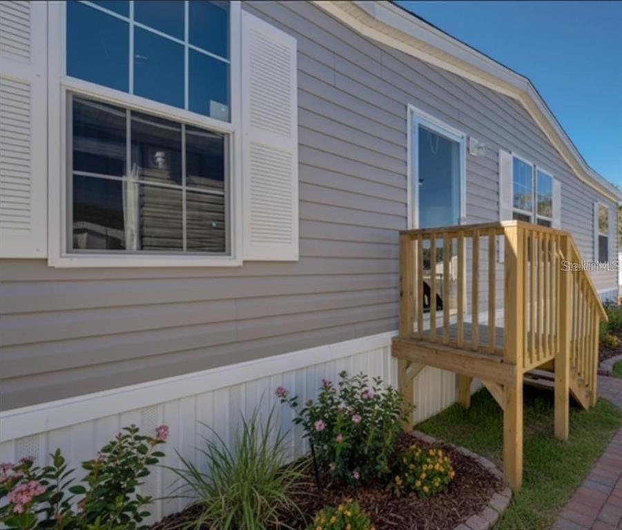 a view of a house with a flower garden