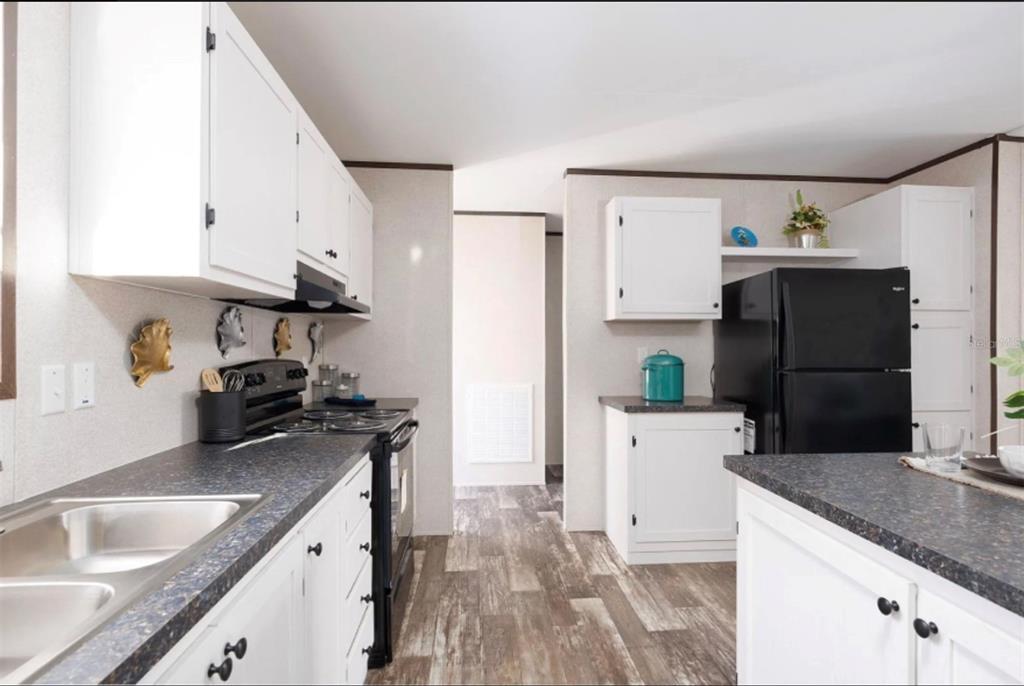 0 Steward Road Eustis, FL 32736 - Photo 8 of 12 a kitchen with granite countertop a refrigerator stove and sink