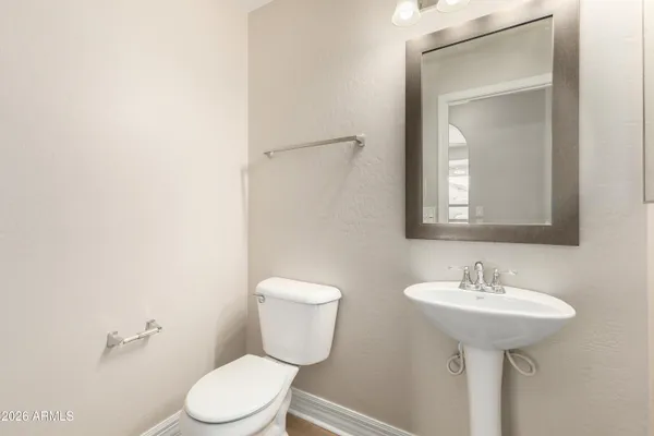 a bathroom with a sink toilet and mirror