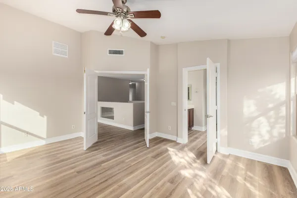 wooden floor in an empty room with a window