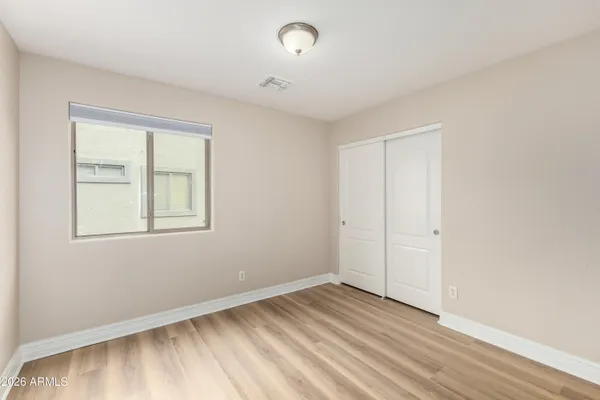 a view of an empty room with wooden floor