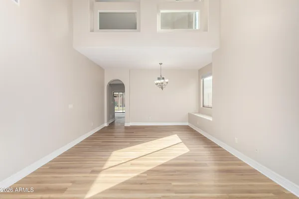 a view of a livingroom with wooden floor and a window