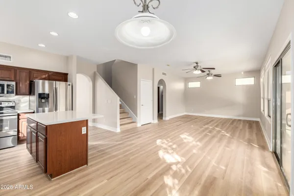 a view of a kitchen with wooden floor and a ceiling fan
