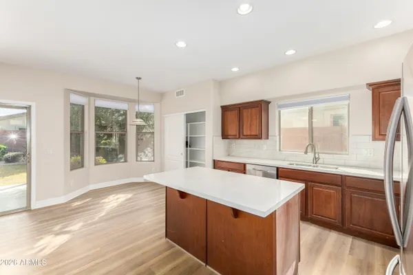 a kitchen with a sink stove and cabinets