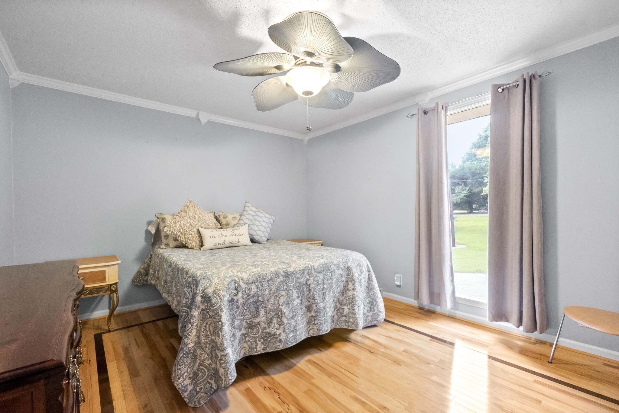 1370 Dunbar Cave Road Clarksville, TN 37043 - Photo 26 of 63 a bedroom with a bed and a chandelier
