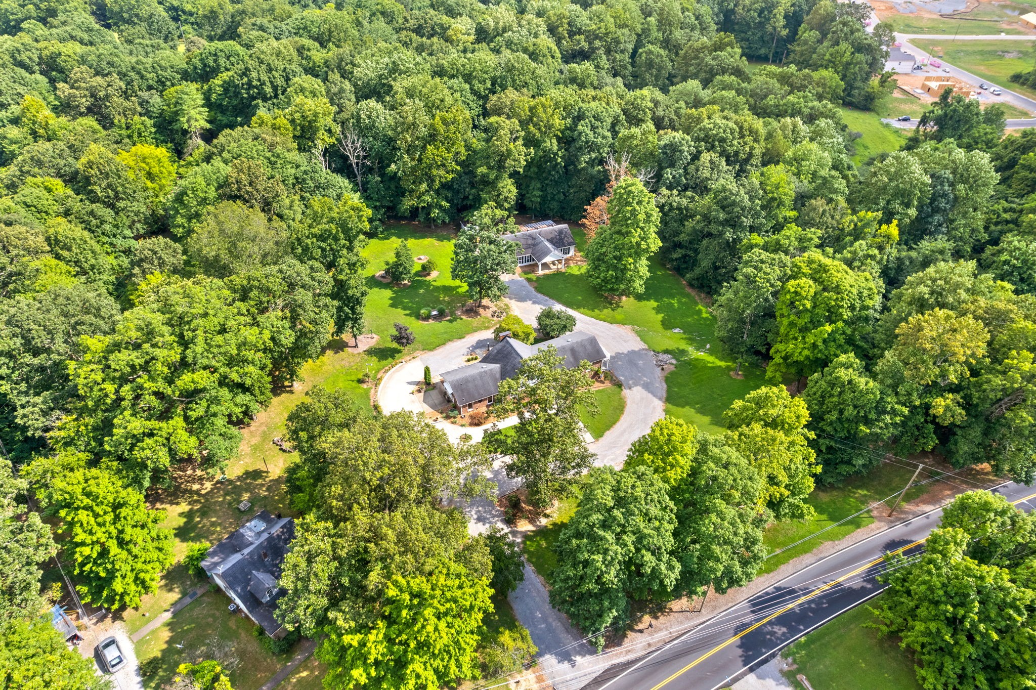 1370 Dunbar Cave Road Clarksville, TN 37043 - Photo 54 of 63 a backyard of a house with lots of green space and garden in the back