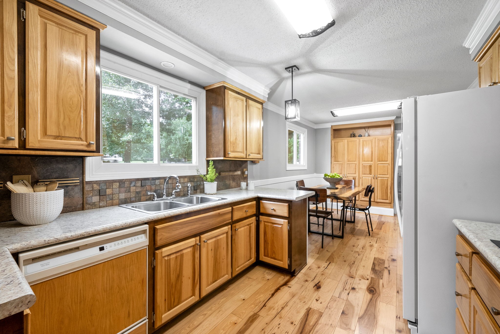 1370 Dunbar Cave Road Clarksville, TN 37043 - Photo 9 of 63 a kitchen with granite countertop sink stove dining table and chairs