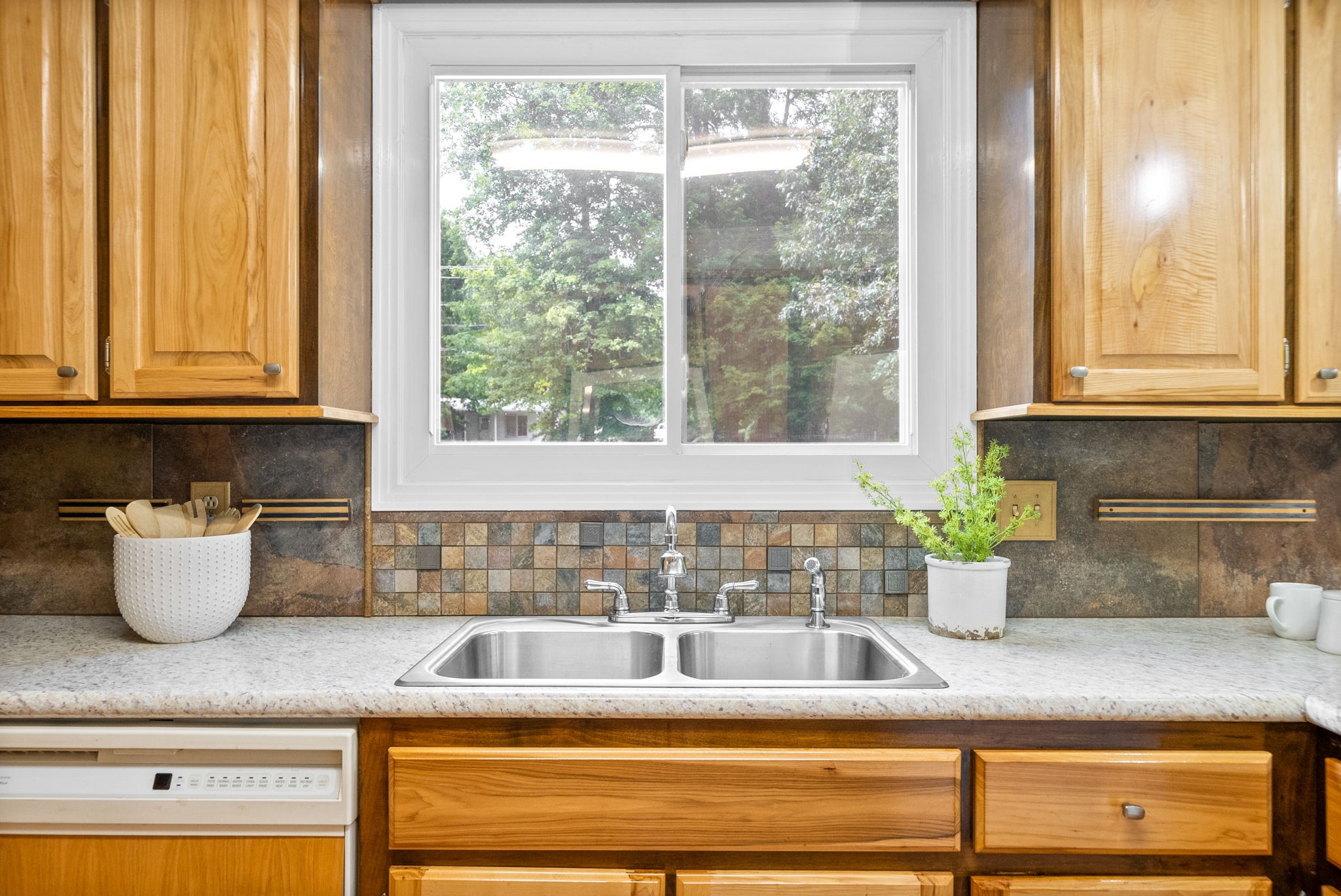 1370 Dunbar Cave Road Clarksville, TN 37043 - Photo 10 of 63 a kitchen with a window sink and cabinets