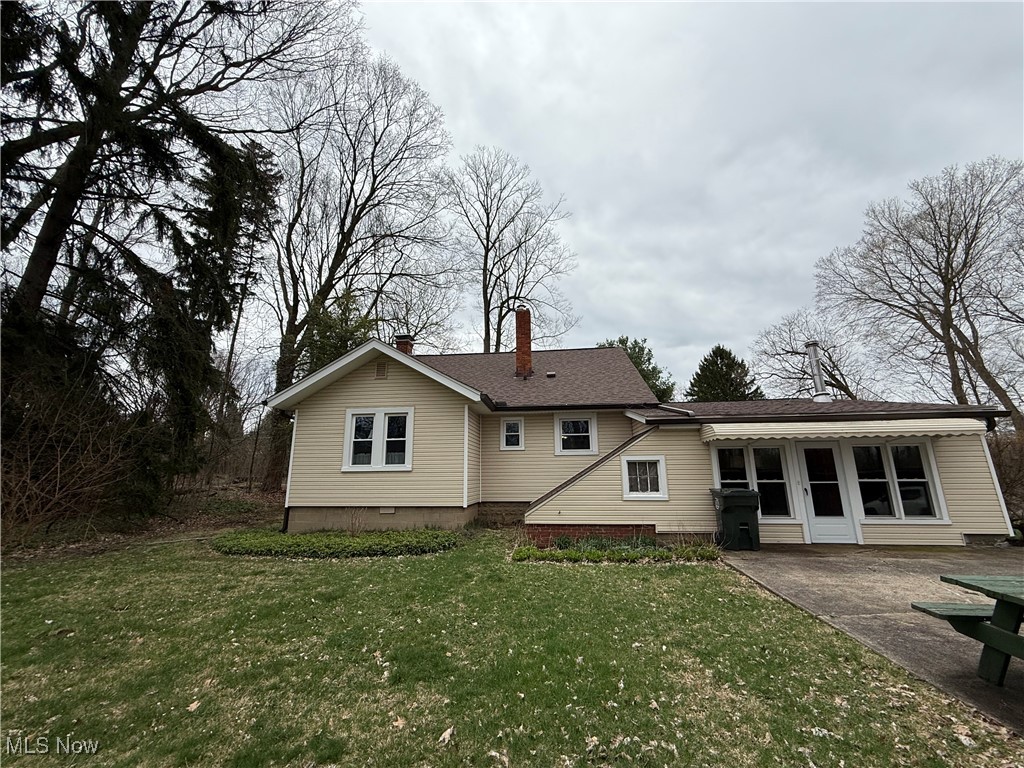 3122 South Medina Line Road Wadsworth, OH 44281 - Photo 7 of 41 Back of property with a patio, a yard, and a chimney