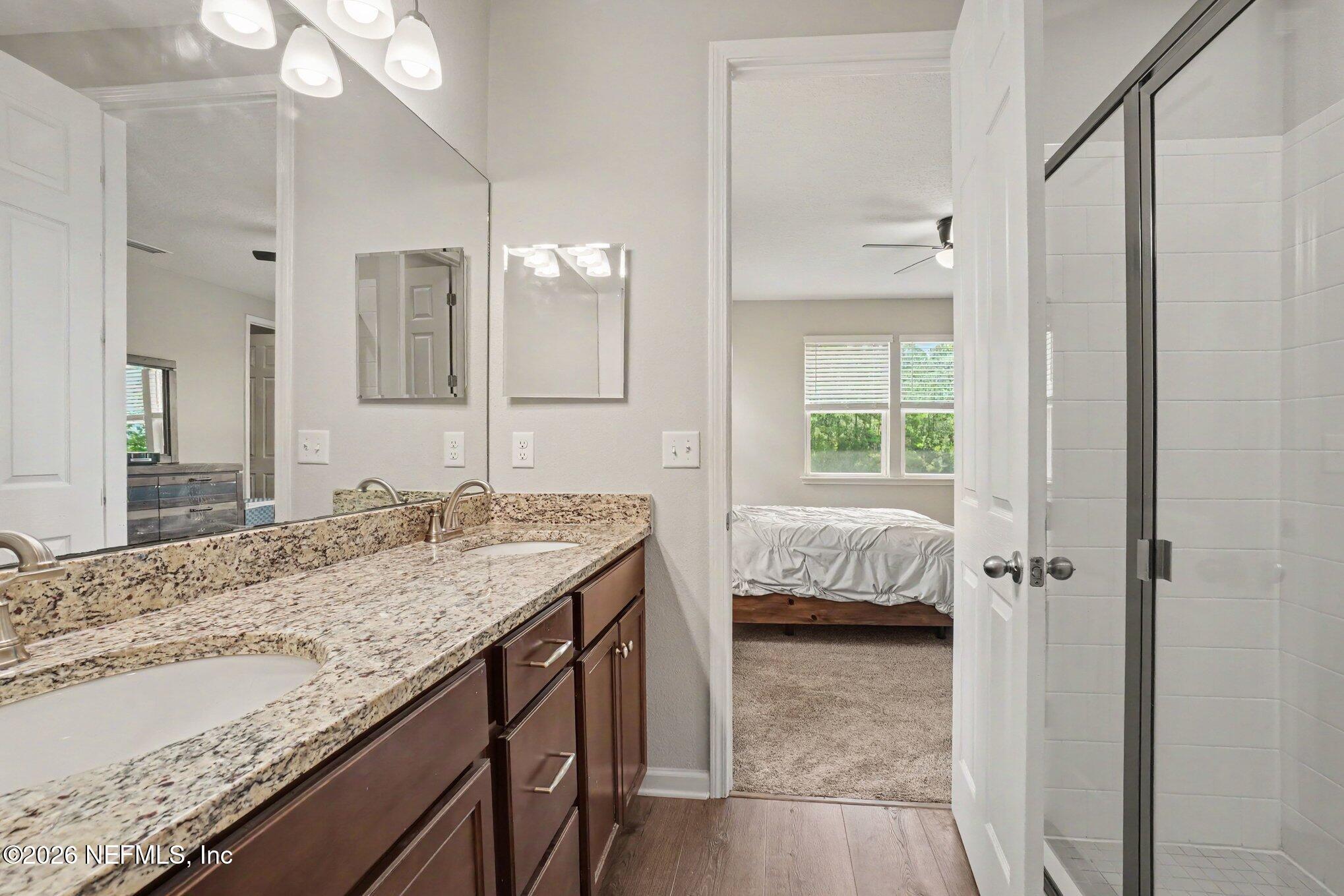 4630 Pine Ridge Parkway Middleburg, FL 32068 - Photo 23 of 35 a en suite bathroom with a granite countertop sink and a mirror